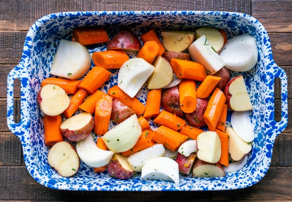 Potatoes and vegetables in a roasting pan
