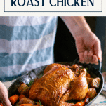 Hands holding a tray of whole roasted chicken with text title box at top