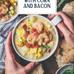 Overhead shot of hands holding a bowl of shrimp and corn chowder with text title overlay