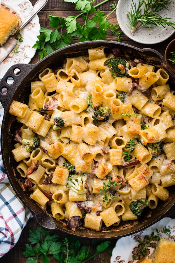 Easy pasta bake recipe in a skillet with broccoli and bacon.
