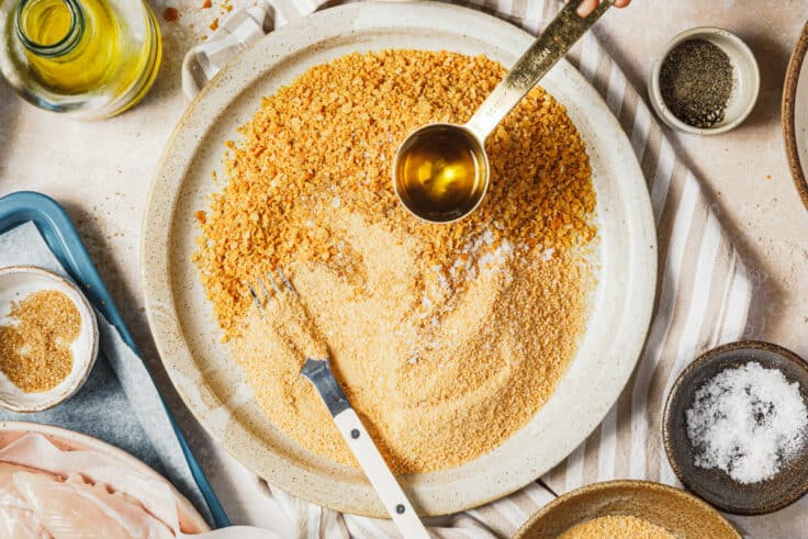 Process shot showing how to make the breading for baked chicken tenders.