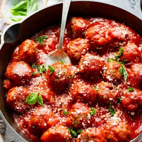Close up square image of a pan of baked meatballs.