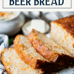 Sliced loaf of cheese beer bread recipe with text title box at top