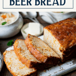 Easy beer bread on a white cutting board with text title box at top