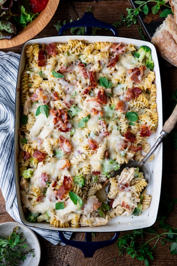 Overhead image of a pan of chicken bacon ranch pasta casserole on a wooden table