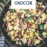 Skillet full of potato gnocchi with chicken and mushrooms and text title overlay