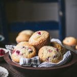 Wooden bowl of the best cranberry muffin recipe on a table.