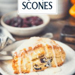 Orange cranberry scone on a plate with text title overlay