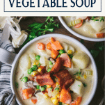 Close overhead shot of creamy vegetable soup in a bowl with text title box at top