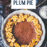 Close overhead shot of damson plum pie with text title overlay