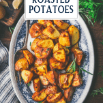 Overhead shot of a plate of garlic rosemary roasted potatoes with text title overlay