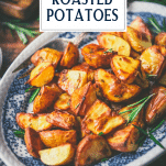 Crispy roasted potatoes on a plate with text title overlay