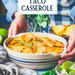 Hands holding taco bake casserole with text title overlay