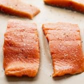 Process shot showing how to make Dijon mustard salmon.