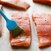 Brushing salmon with a brown sugar and Dijon mustard glaze.