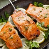 Square side shot of brown sugar roasted Dijon mustard salmon in a cast iron pan.