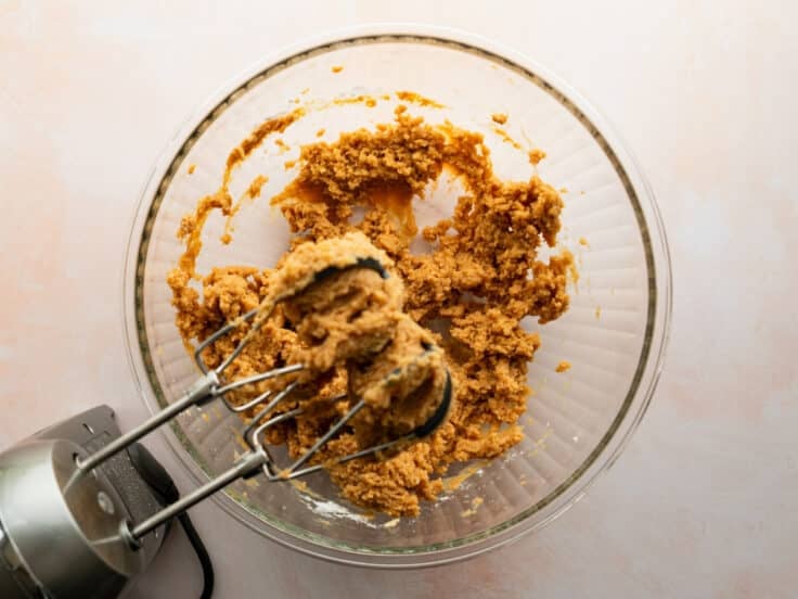 Mixing the powdered sugar into the peanut butter mixture.