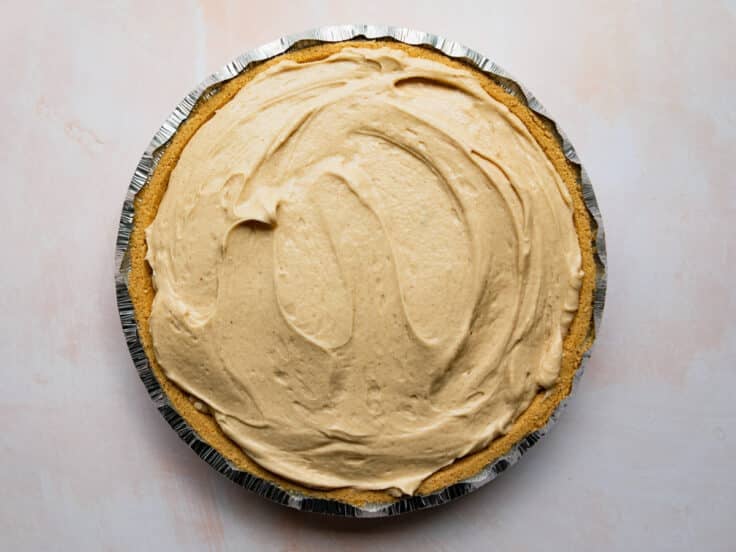 Spreading the filling in the graham cracker crust.