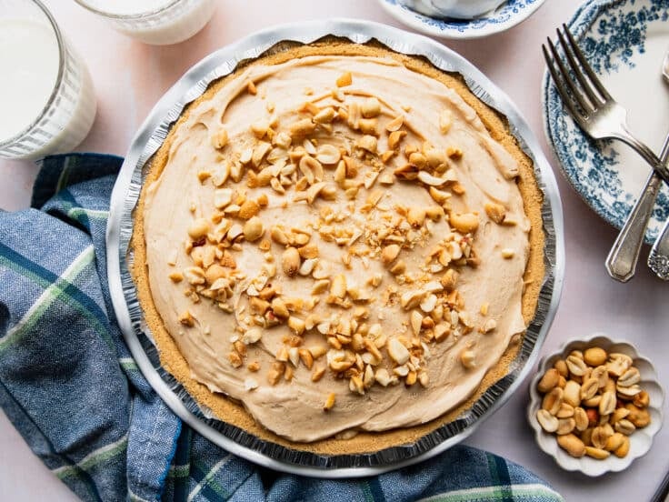 No bake peanut butter pie with chopped peanuts on top.