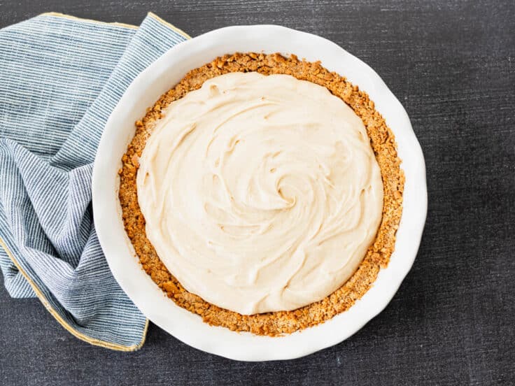 Adding the filling to peanut butter pie.