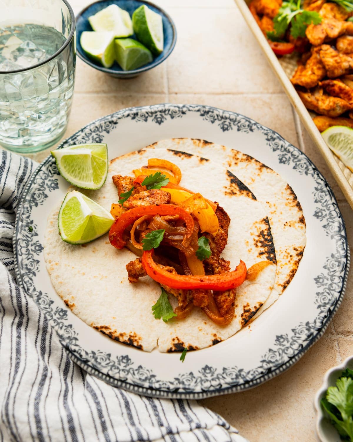 Side shot of sheet pan chicken fajitas on a table.