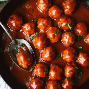 Close overhead image of bbq meatballs in a cast iron skillet
