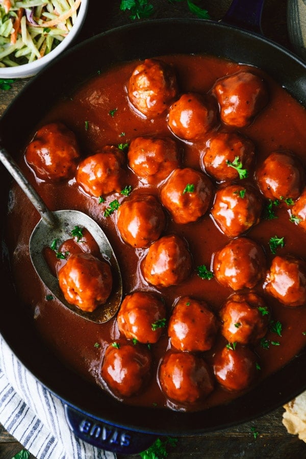 Close overhead image of bbq meatballs in a cast iron skillet