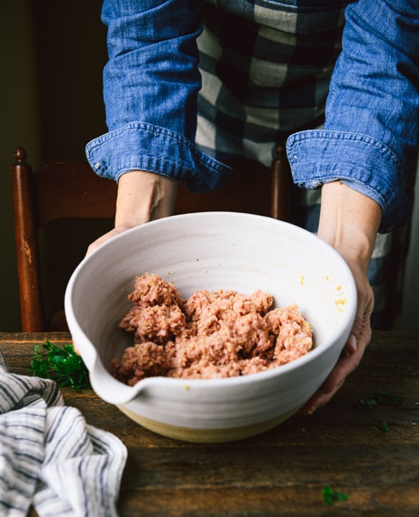 Ground meat mixture in a large white bowl