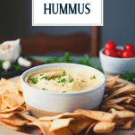 Side shot of a bowl of hummus with text title overlay