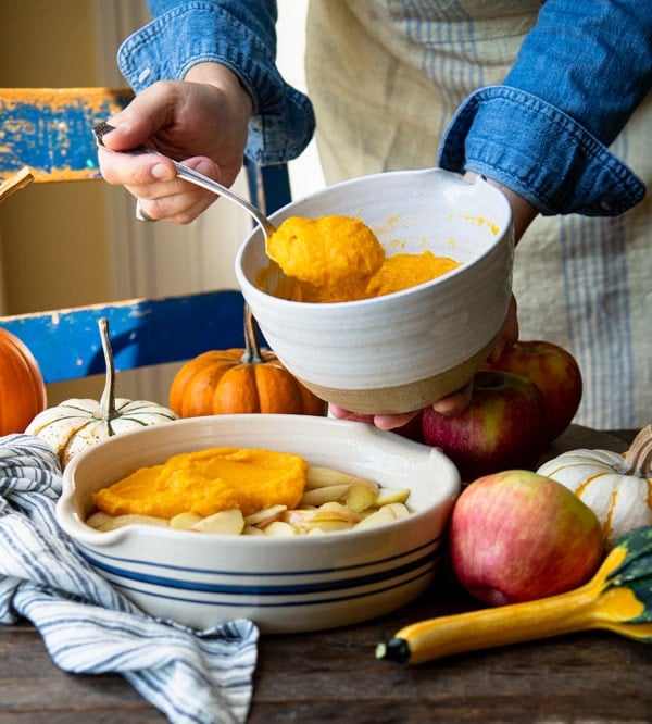 Adding mashed butternut squash to the top of a casserole