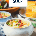 Side shot of a white bowl full of cheeseburger soup with text title overlay