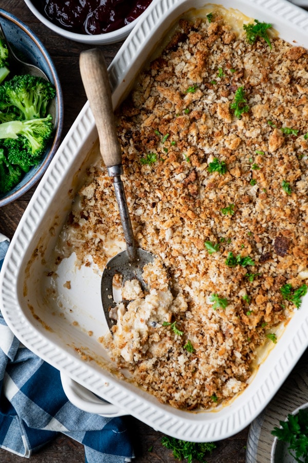 Close overhead image of easy chicken and stuffing casserole with a serving spoon in it.