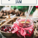 Spoon in a jar of Christmas jam with text title box at top