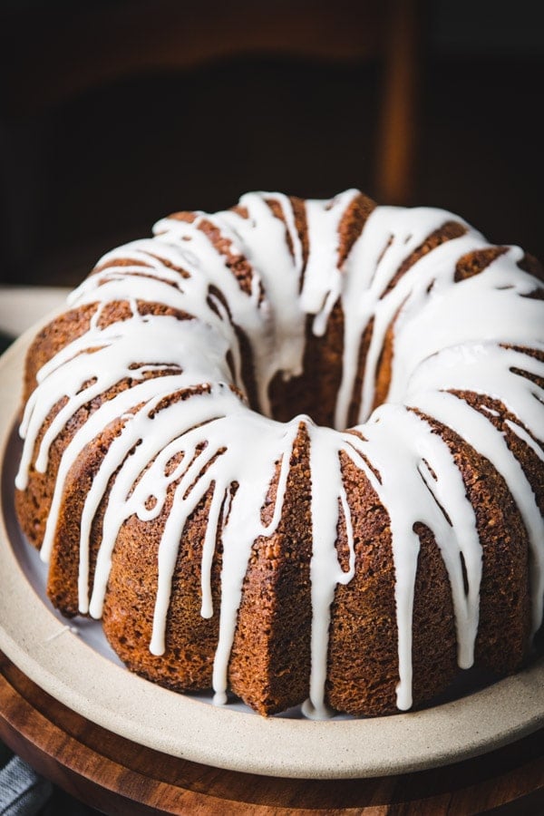 Close up shot of cinnamon coffee cake in a bundt pan with vanilla glaze