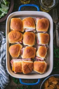 Overhead shot of ham and cheese sliders with brown sugar in a baking dish