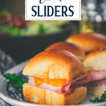 Close up side shot of a tray of hawaiian ham and cheese sliders with text title overlay