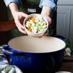 Adding carrots celery and onion to a Dutch oven