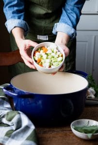 Adding carrots celery and onion to a Dutch oven