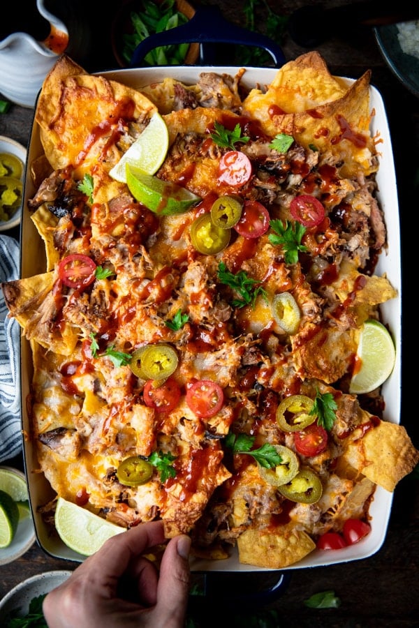 Overhead image of the best pulled pork nachos recipe with all of the fresh toppings