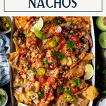 Pan of loaded nachos pulled pork with text title box at top