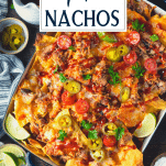 Overhead shot of a pan of smoked pulled pork nachos with text title overlay