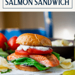 Roasted salmon sandwich on a dinner table with text title box at top
