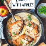 Overhead shot of cast iron skillet chicken breast with apples and text title overlay