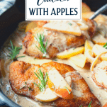 Close up side shot of chicken and apples in a cast iron skillet with text title overlay