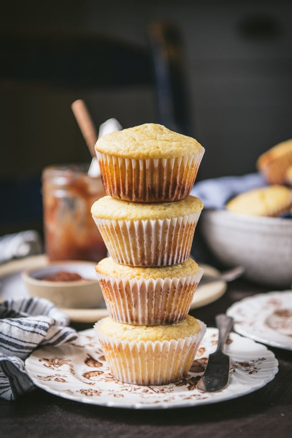 Four buttermilk cornbread muffins stacked on a plate