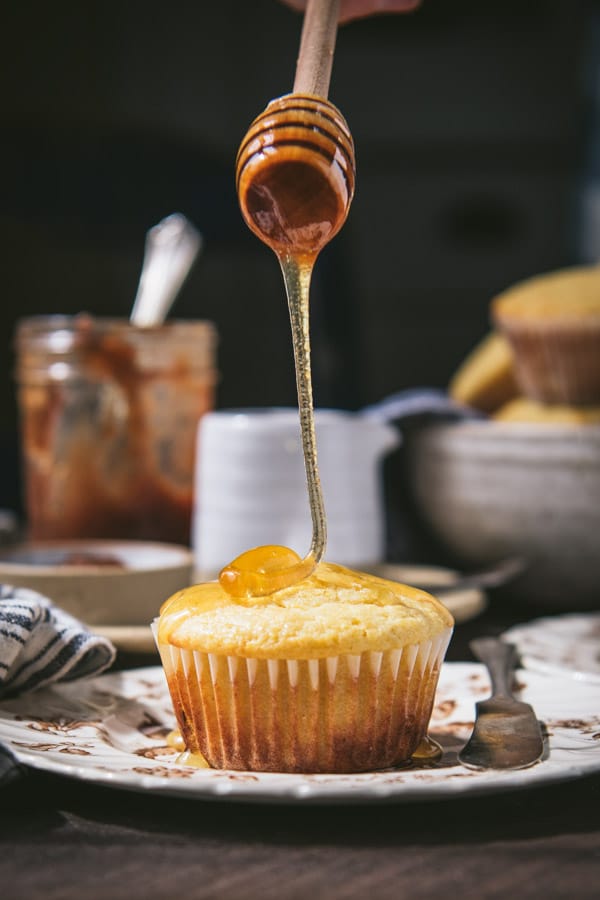 Drizzling honey on sweet cornbread muffin