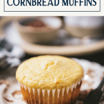 Close up shot of a sweet cornbread muffin on a plate with text title box at top