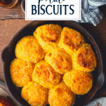 Overhead shot of a skillet full of sweet potato biscuits with text title overlay