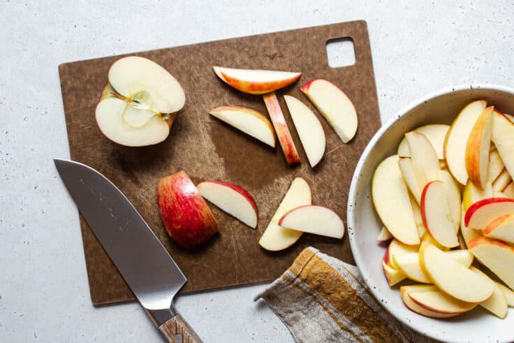 Slicing apples on a cutting board.