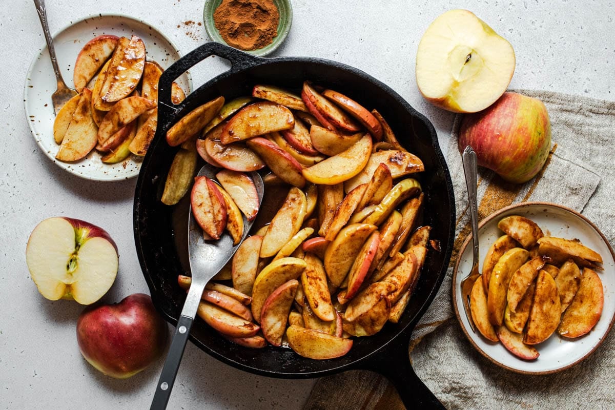 Horizontal overhead shot of easy baked apple slices in a cast iron pan.